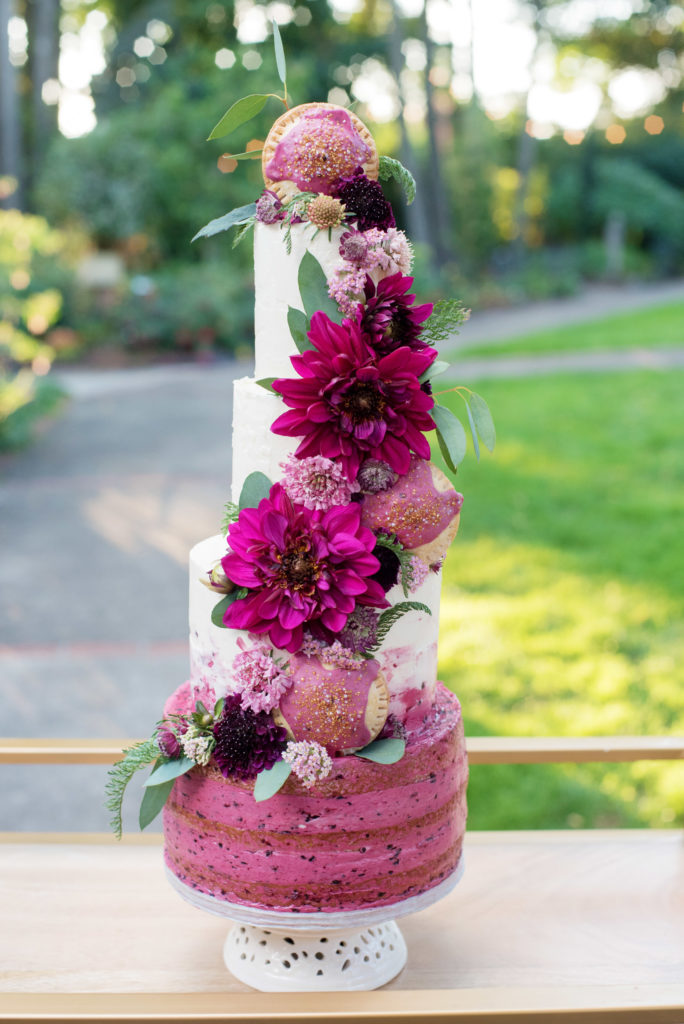 a magenta wedding cake with marionberry poptarts and pink flowers by the pastry smith
