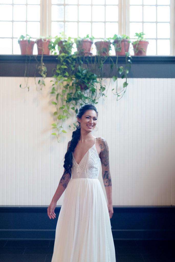 bride in low cut vneck wedidng dress from a&be at the evergreen pdx