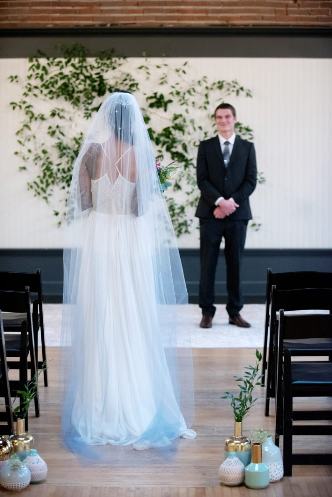 bride wears a blue ombre veil and a low cut v-neck wedding dress from a&be bridal