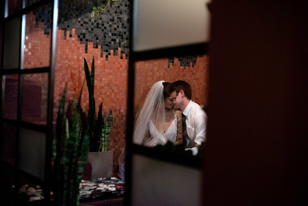 Bride and groom get cozy in the speakeasy Voysey bar under Loyal Legion and the Evergreen