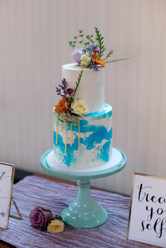 pastel blue watercolor wedding cake with flowers